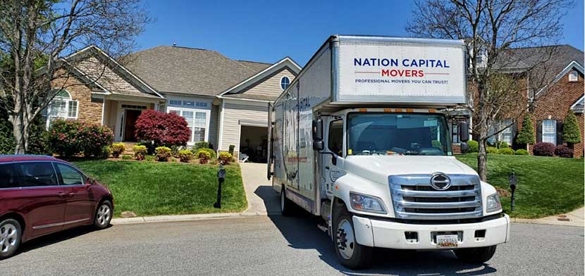 Our moving truck in front of a house for local relocation.